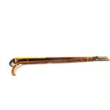 A collection of six walking sticks including 9ct Gold, Silver topped sticks,