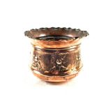 An Arts and Crafts embossed Copper jardinière with wavy rim,