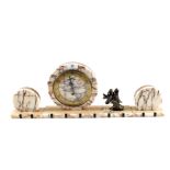 An Art Deco variegated marble clock garniture with metal bird mount