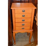 A jewellery cabinet in the form a three drawer chest and a small Pine bench with storage