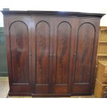 A large four door Mahogany breakfront wardrobe with flared door panels, height 83",