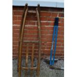 A wooden snow sledge with metal runners