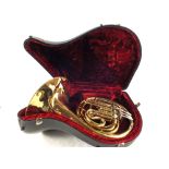 A cased Brass Faxman student French horn