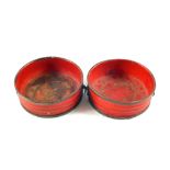 A pair of antique red lacquer papier mache wine coasters,