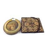 A gilt thread evening bag and a circular Brass framed picture on metal of a seated girl with anchor