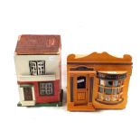 A wooden bakers shop with model cakes and bread plus a small dolls house