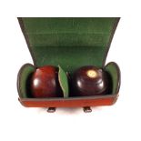 A cased pair of lawn bowls