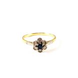 An 18ct Gold Sapphire and white stone set floral design ring,