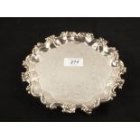 A Silver shaped edge salver on scroll feet,