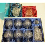 A boxed Bohemian crystal decanter set and two jugs