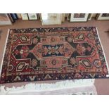 A Hamadan rug with geometric central lozenges,