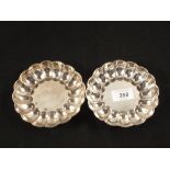 A pair of Silver scalloped edge dishes,