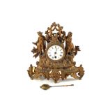 A gilt spelter figure mounted mantel clock