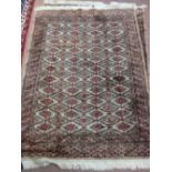 A pair of Persian style red ground geometric rugs,