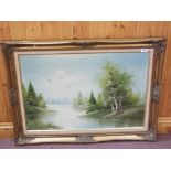 Gilt framed oil on canvas of a lake view,