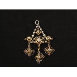 A white metal (believed to be Platinum) and Gold pendant set with Diamonds and Rubies in flower