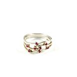 A 9ct White Gold ring set with eight small red stones,