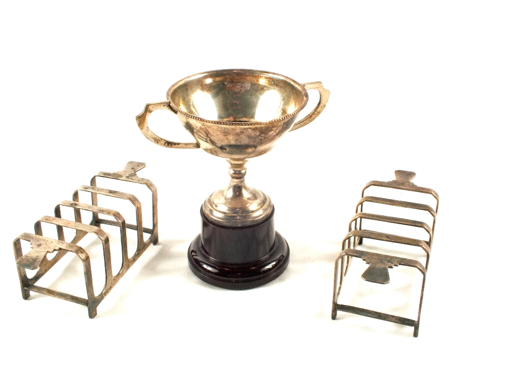 A pair of Silver toast racks and a small Silver trophy cup