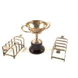 A pair of Silver toast racks and a small Silver trophy cup