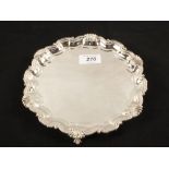 A Silver shaped edge salver on claw and ball feet,