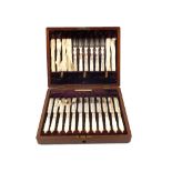 A Mahogany canteen of twenty four Silver plated and Mother of Pearl tea knives and forks