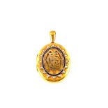 A large Gold double photo locket with blue enamel and Seed Pearl decoration (crest engraved to back,