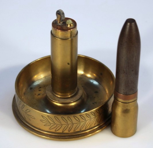 A quantity of brassware, comprising a trench art cigarette lighter and ashtray, centred with a - Image 2 of 2