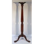A 19thC mahogany torchère, the circular moulded top raised above a double baluster column on