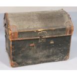 An early 20thC domed top trunk, in pressed leather with shaped fixed handles, the shaped lid hinging