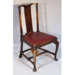 A George I style oak dining chair, with a shaped comb back raised above a plain splat, flanked by