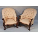 A pair of 19thC rosewood armchairs, in the manner of Gillows, with heavily carved floral and leaf