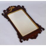 A 19thC mahogany fret mirror, the pierced frame centred with a gilded ho-ho bird, above a shaped