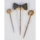 Three various stick pins, to include one set with a bow, 6cm high, horseshoe, and a seed pearl