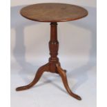 An 18thC oak occasional table, the plain circular top raised on a baluster column terminating in