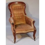 A Victorian mahogany open armchair, the shaped spoon back raised above scroll arm supports,