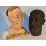 A studio plaster bust of a gentleman, quarter profile with beaming expression on a wooden stand,