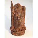 An African carved hardwood figure, formed as a head, of polished form, 29cm high.