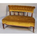 An Edwardian mahogany nursing settee, of good proportion, the scroll back raised on baluster pillars