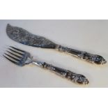 A pair of Victorian silver fish servers, of bright cut decoration with rococo scroll handles and