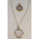 A photographic pendant, with glazed sides, attached to a slender link chain, yellow metal, stamped
