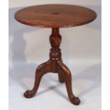 A 20thC oak table, of heavily carved form, the plain circular top with moulded outline on baluster