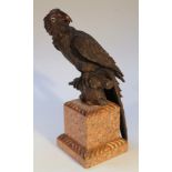 A bronzed figure of a parrot, perched on a tree branch and raised on a part gadrooned textured