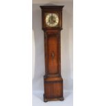 An early 20thC oak grandmother clock, the square hood with a fixed cornice revealing a 10" brass