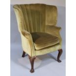 A 19thC George I style walnut framed porter's chair, the tub back and shaped arms upholstered in (