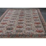 An Axminster style woollen rug, of rectangular form, predominantly white background with