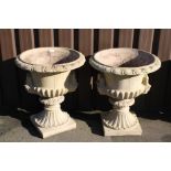 A pair of Victorian style campana garden urns, the inverted bodies part gadrooned and flanked by