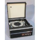 A mid-20thC Bush record player, with articulated plastic arm, in a pressed leather case with front