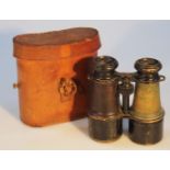 A pair of early 20thC metal field binoculars, of extending articulated form, each with pressed