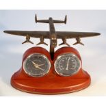 A Bradford exchange Avro Lancaster bomber clock, of typical form with polished wooden stand, gilt