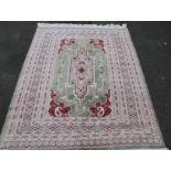 A machine woven hearth rug, of geometric pattern in red, green and black, of modern construction,